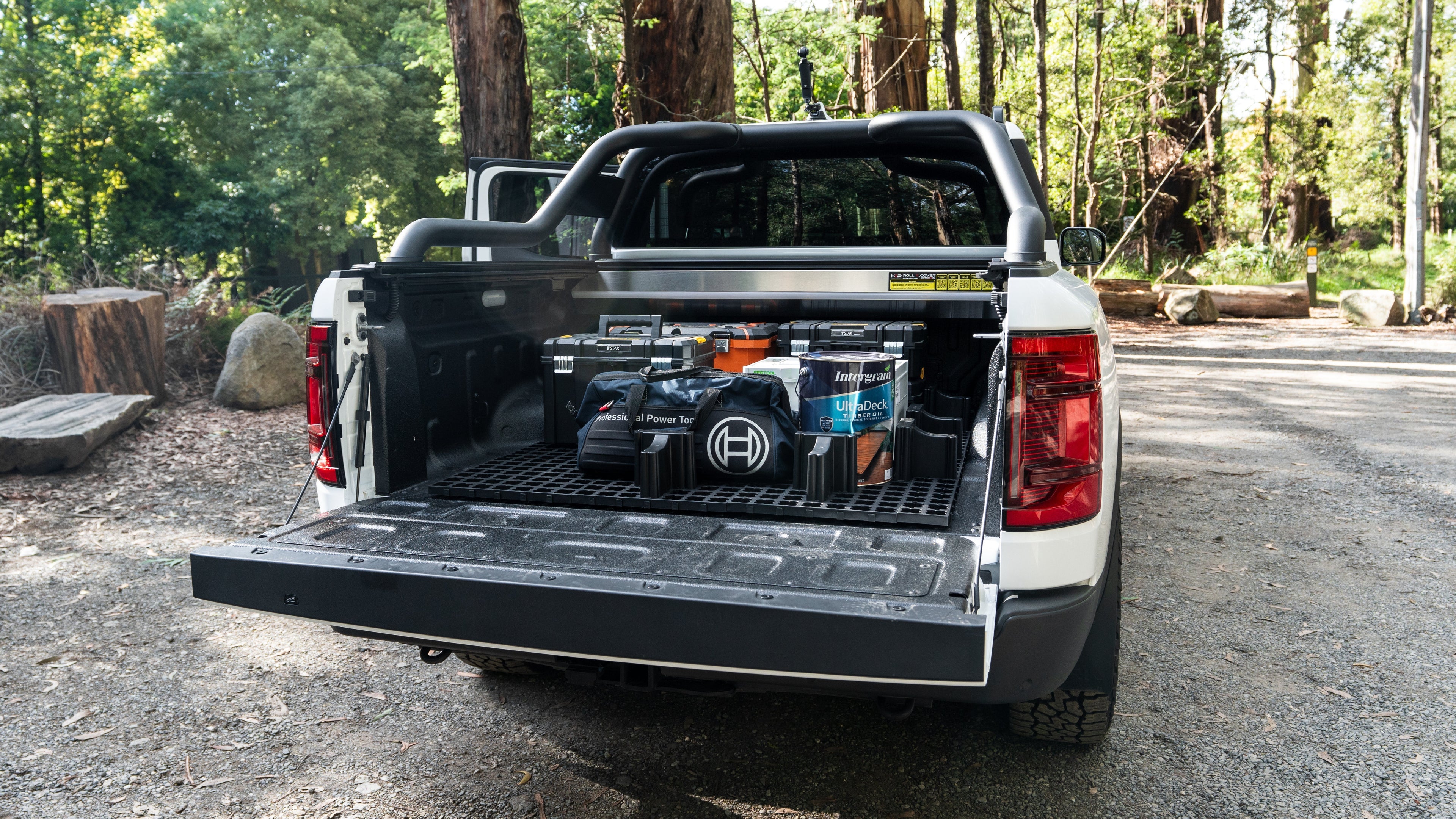 Open ute tray/tub camping setup with LockNMat modular organiser, storage boxes and 4WD touring gear